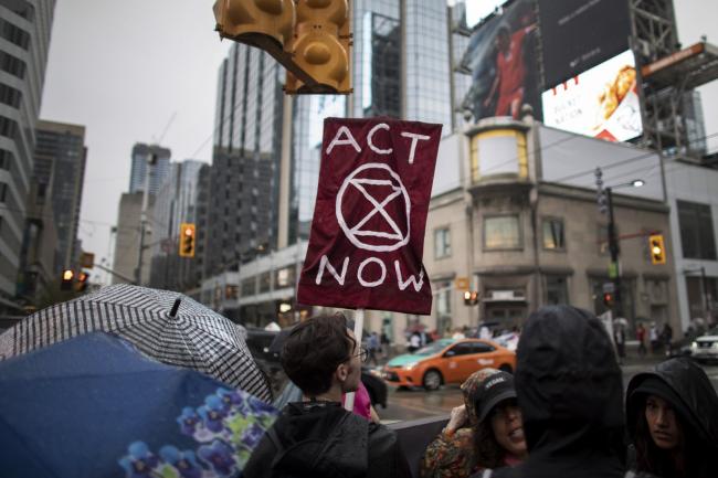 Protestors, joined by faith leaders and members of Extinction Rebellion Toronto, take over the intersection of Yonge and Dundas streets in Downtown Toronto as part of a demonstration declaring a climate crisis on June 10, 2019. Photo by Nick Iwanyshyn