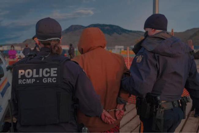 A photo posted to the Secwepemc Virtual Unity Camp Facebook page shows RCMP officers making an arrest last week near the drill site of the Trans Mountain pipeline expansion project. Facebook / Secwepemc Virtual Unity Camp