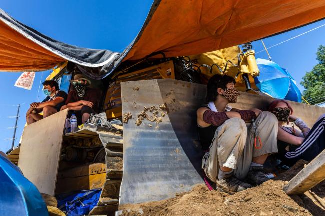 Environmental activists chain themselves to construction equipment at a Line 3 pipeline pumping station near Itasca State Park, Minnesota, on June 7, 2021. KEREM YUCEL / AFP VIA GETTY IMAGES