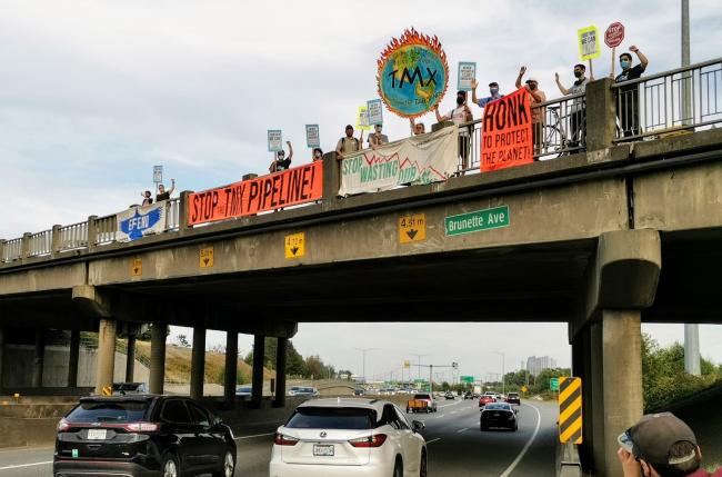 photos of TMX highway overpass banner drop in Burnaby