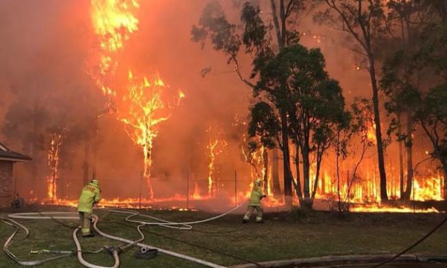  ‘The need to keep the wheels of capitalism well-oiled takes precedence even against a backdrop of fires, floods and hurricanes.’ Photograph: Fire & Rescue NSW/AFP/Getty Images