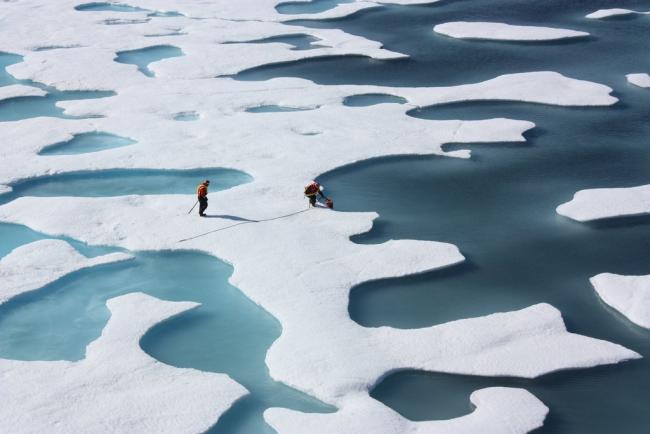 File photo of researchers on a NASA-funded mission examining melt ponds in the Arctic near Alaska, July 12, 2011. Photo by NASA