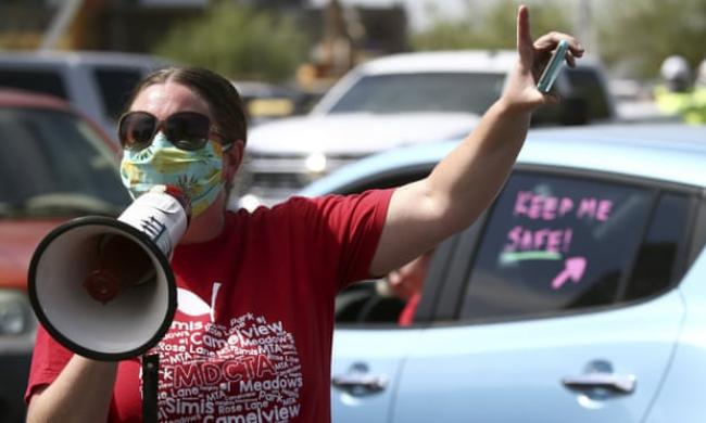 Teachers hold a ‘#Return2SchoolSafely’ protest in Phoenix, Arizona, on 15 July. Photograph: Ross D Franklin/AP
