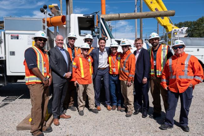 Prime Minister Justin Trudeau (centre) with B.C. Premier John Horgan and hydro workers at a training centre in Surrey, B.C. on Aug. 29, 2019. B.C. Government Photo