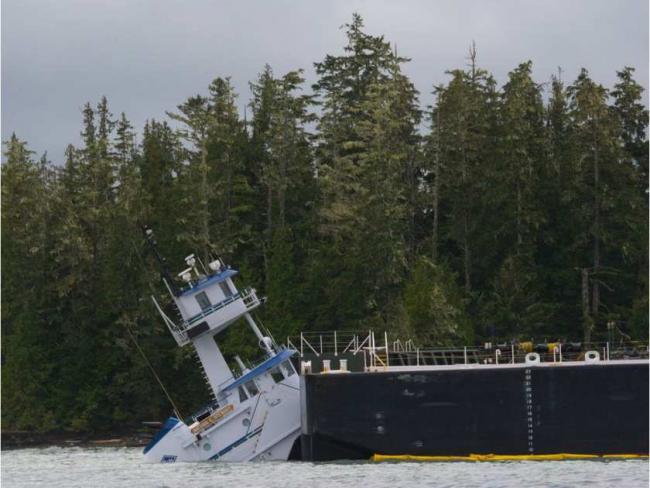 A tug and barge that carries petroleum products to and from Alaska through B.C.'s Inside Passage has run aground near Bella Bella. The Canadian Coast Guard confirms the Nathan E. Stewart, an articulated tug/barge owned by the Texas-based Kirby Corporation, ran aground at Edge Reef in Seaforth Channel just after 1 a.m. Thursday. The coast guard says the 287-foot long fuel barge was empty, but the 100-foot tug itself is leaking diesel fuel. People on the scene at noon said that the tug was half under water an