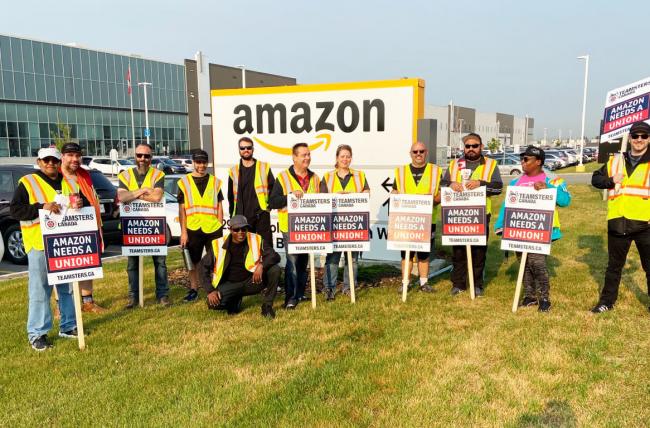 Members of Teamsters Locals 987 and 362 protest outside an Amazon fulfillment center in Alberta, Canada, on July 14, 2021, after meeting with Amazon workers across the country to discuss working conditions and union organizing. COURTESY: TEAMSTERS CANADA