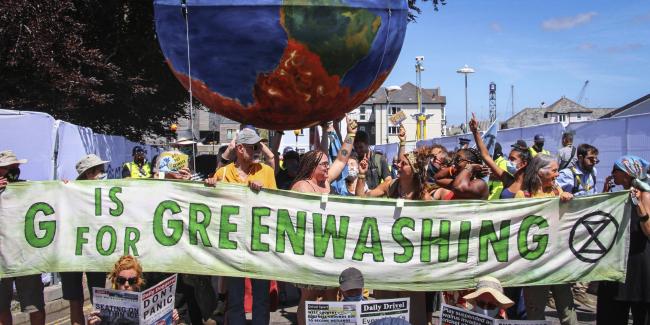 Protesters critical of the Group of Seven countries’ climate policy call for strong action on climate change during a rally in Cornwall, England, on June 12, 2021. Photo: Kyodo via AP Images