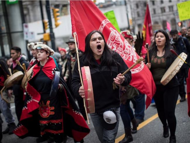 Alex Spence, centre, who is originally from Haida Gwaii, beats a drum and sings during a march in support of pipeline protesters in northwestern British Columbia, in Vancouver, on Tuesday.	DARRYL DYCK / THE CANADIAN PRESS