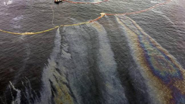 Fuel slicks spread around the tug Nathan E. Stewart, stranded on a reef it struck. (Marilyn Slett)