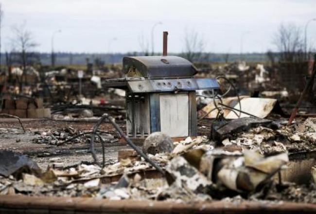 The burnt remains of a barbecue are pictured in the Beacon Hill neighbourhood of Fort McMurray, Alberta, Canada, May 9, 2016 after wildfires forced the evacuation of the town.  REUTERS/Chris Wattie
