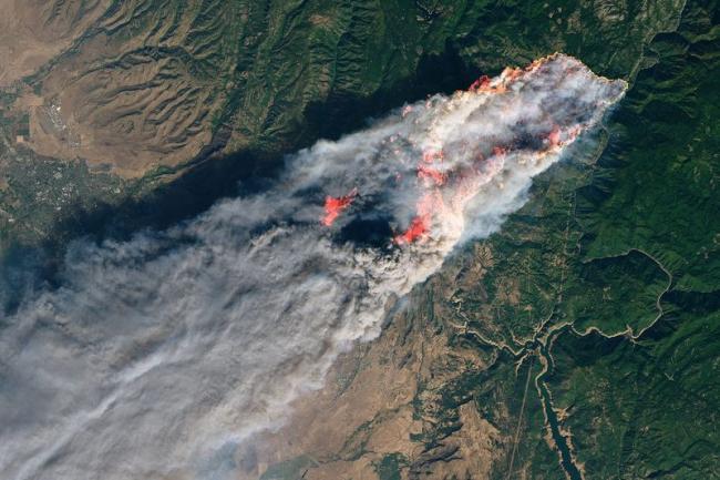 The wildfire that wiped out Paradise, California, viewed from space. At last count, there were 88 confirmed dead, 296 missing, The fire destroyed 13,972 homes, 528 commercial buildings and 4,293 other structures. (NASA)