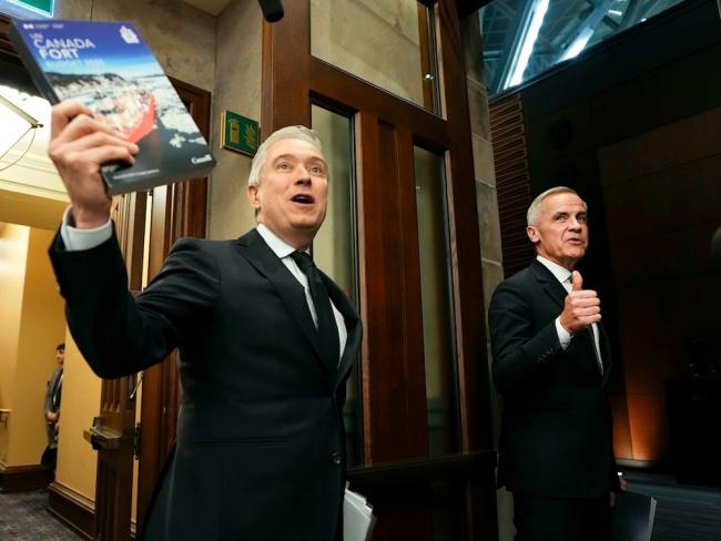 Prime Minister Mark Carney, right, and Finance Minister François-Philippe Champagne, left, make their way into the House of Commons for the tabling of the federal budget Tuesday. Photo by Justin Tang, the Canadian Press.