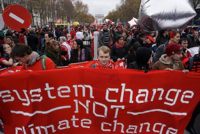 Climate activists denounce the Paris climate agreement, saying it will only aggravate climate change and intensify global warming, during a protest march on Dec. 12. (Photo: Clemente Bautista)