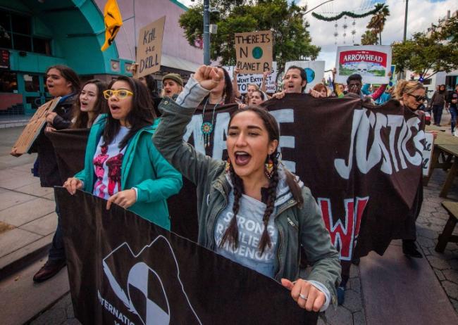Students and their supporters protest as they demand transformative climate change action during the Black Friday sales in Santa Monica, California, on November 29, 2019.