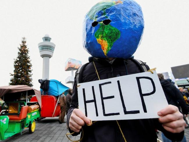 A man demonstrates as Greenpeace stages a climate protest at Amsterdam Schiphol Airport in Netherlands on Dec. 14, 2019.Piroschka van de Wouw/Reuters