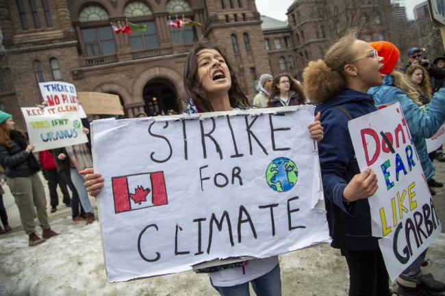 Students walked out of school to gather on the south lawn of Queens Park in Toronto to rally for climate change on March 15, 2019. Photo by Carlos Osorio