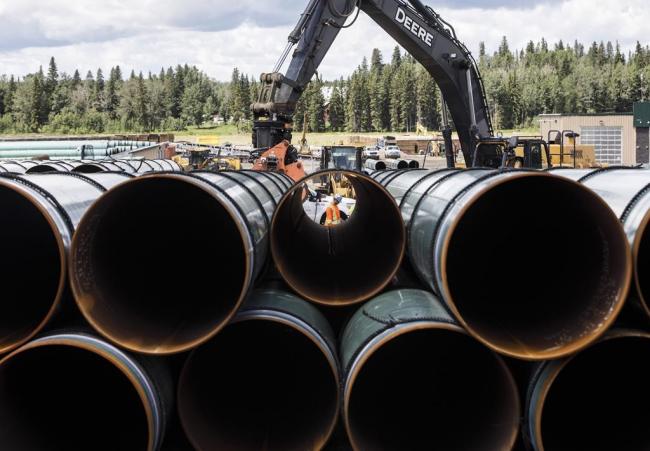 FILE: Pipe for the Trans Mountain pipeline are unloaded in Edson, Alta. on June 18, 2019. THE CANADIAN PRESS/Jason Franson