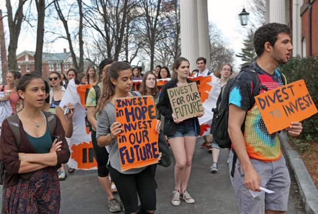 Students and alumni at Tufts University protest near the Tufts University presidents office in Medford, Mass. on April 22, 2015, and began a sit-in that they said would continue until the administration commits to fossil fuel divestment. (Photo: David L. Ryan / The Boston Globe via Getty Images)