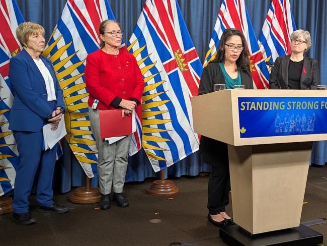 Care aide Edil Bukid said the changes are ‘about dignity for workers, for seniors and for their families who trust us.’ She was joined by the HEU’s Lynn Bueckert, MLA Susie Chant and Health Minister Josie Osborne for the announcement. Photo for The Tyee by Andrew MacLeod.