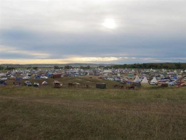 More than a thousand people gather at an encampment near North Dakota's Standing Rock Sioux reservation on Friday, Sept. 9, 2016. The Standing Rock Sioux tribe's attempt to halt construction of an oil pipeline near its North Dakota reservation failed in federal court Friday, but three government agencies asked the pipeline company to "voluntarily pause" work on a segment that tribal officials say holds sacred artifacts. (AP Photo/James MacPherson)