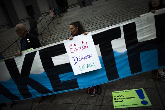 People take part in a protest against ExxonMobil before the start of its trial outside the New York State Supreme Court building on Oct. 22, 2019 in New York. Credit: Eduardo MunozAlvarez/VIEWpress