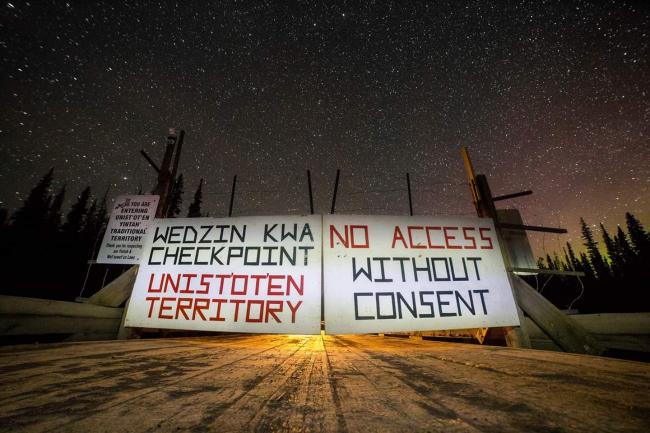 Visitors to Unist'ot'en territory are greeted with a sign ensuring there's no confusion around their recognized governance. Photo by Jeffrey Nicholls