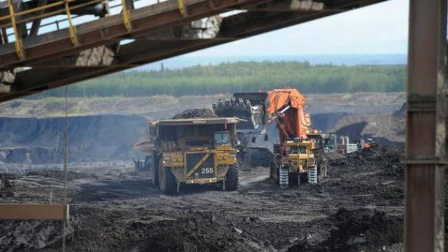 Heavy machinery operates in the pit at the Shell Albian Sands located in Alberta's oil sands north of Fort McMurray. Canadian premiers are set to sign a deal to fast-track new oil sands projects. (Kevin Van Paassen/The Globe and Mail)