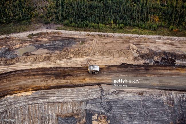 A heavy hauler truck drives through a mine above the Athabasca oil sands near Fort McMurray, Alberta, Canada. Photographer: Ben Nelms/Bloomberg