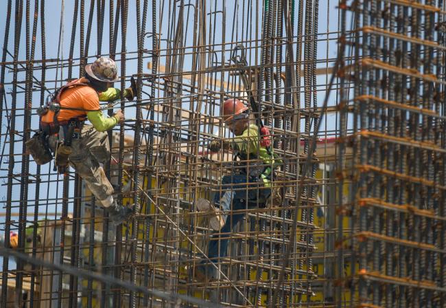 Construction workers are seen as they work with steel rebar during the construction of a building on May 17, 2019 in Miami, Florida. Joe Raedle / Getty