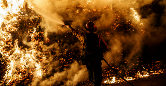 Firefighters sprays water on a back fire while battling the spread of the Maria Fire as it moves quickly towards Santa Paula, California, on Nov. 1, 2019. (Photo: Marcus Yam/Los Angeles Times via Getty Images)
