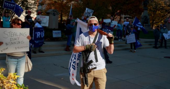 A man carries an AR-15 assault rifle and a flag as protesters gather near the Indiana State house for a #StoptheSteal rally and to protest Joe Biden's election victory over President Donald J. Trump. The election was called in favor of Biden shortly before the rally began. (Photo: Jeremy Hogan/SOPA Images/LightRocket via Getty Images)