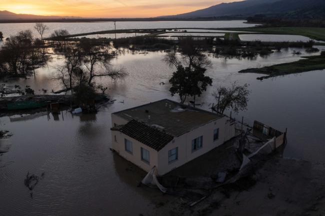 In an aerial view, flooding continues to cover much of the Salinas Valley after a series of powerful storms caused the overflow of the Salinas River on January 18, 2022 near Chualar, California. DAVID MCNEW / GETTY IMAGES