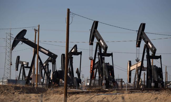 Oil pumpjacks line the horizon in Chevron's Kern River Oil Field, one of the largest in the United States, located just north and east of Bakersfield, on July 7, 2021, in Oildale, California. GEORGE ROSE / GETTY IMAGES