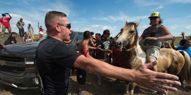 Native American protesters and their supporters are confronted by private security guards at a work site for the Dakota Access pipeline, near Cannon Ball, N.D., on Sept. 3, 2016. Photo: Robyn Beck/AFP/Getty Images