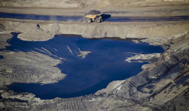 A dump truck drives through the Suncor Energy Inc. oil sands mine in this aerial photograph taken near Fort McMurray, Alberta, in 2015.  (BLOOMBERG VIA GETTY IMAGES)