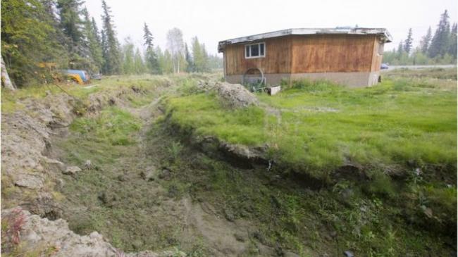 Houses like this one near Fairbanks have collapsed because of permafrost melt - Science Photo Library
