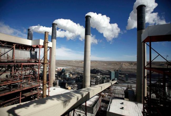 Steam rises from the stacks of the coal-fired Jim Bridger Power Plant outside Point of the Rocks, Wyo., in 2014. Credit Jim Urquhart/Reuters