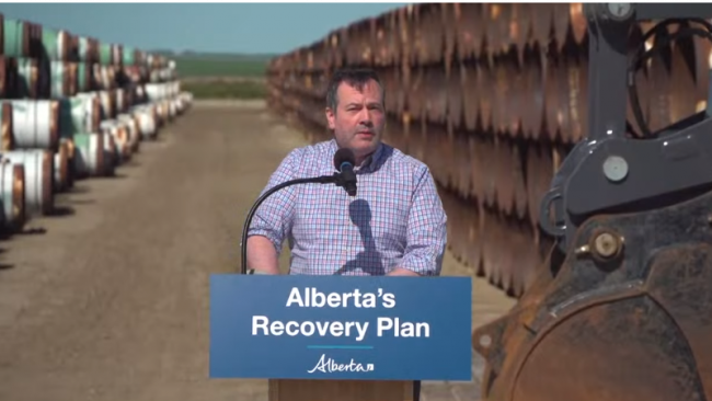 Alberta Premier Jason Kenney with pipe destined for the Keystone XL pipeline, July 3, 2020. Photo by Government of Alberta