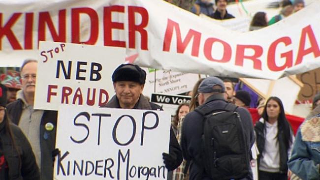 Grand Chief Stewart Phillip of the Union of B.C. Indian Chiefs leads a protest against expansion of the Kinder Morgan Trans Mountain pipeline on Jan. 19, while National Energy Board hearings continue in Burnaby. (CBC)