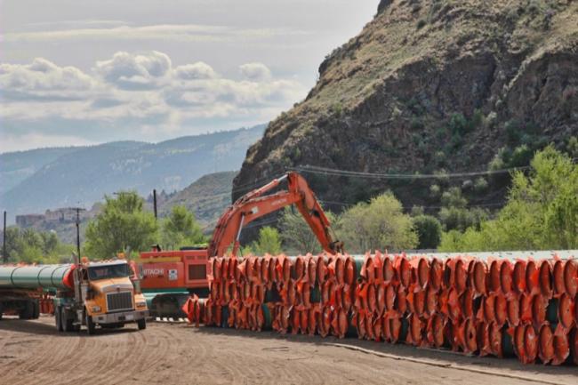 Pipe for Kinder Morgan's planned Trans Mountain pipeline expansion is piled high on Mission Flats Road in Kamloops. Photograph By DAVE EAGLES
