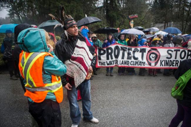 Will George (centre) speaks with organizers during a protest at the gates of Kinder Morgan's Burnaby Mountain facility on Saturday, April 7, 2018.  The next day, Kinder Morgan announced it is pulling all non-essential spending from its Trans Mountain pipeline project.  (JESSE WINTER / STARMETRO, VANCOUVER)