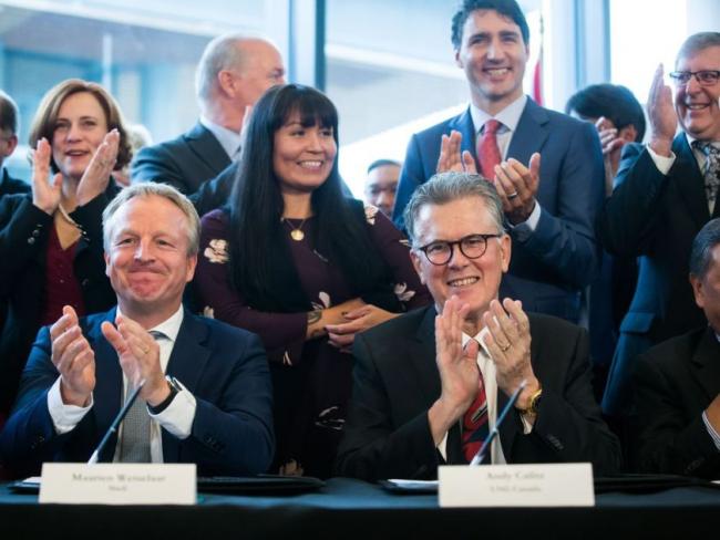 Shell Integrated Gas & New Energies Director Maarten Wetselaar, front left, LNG Canada CEO Andy Calitz, front right, and Prime Minister Justin Trudeau, back right, applaud after a final investment declaration was signed by LNG Canada joint venture participants to build an LNG export facility in Kitimat, during a news conference in Vancouver on Tuesday, Oct. 2, 2018. DARRYL DYCK / THE CANADIAN PRESS