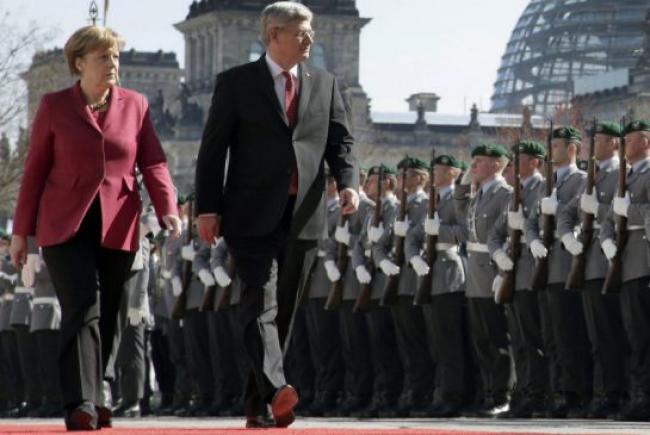 German Chancellor Angela Merkel, left, and Prime Minister Stephen Harper didn't publicly address the question of Canada's ability to fill a resource gap that could follow reduced European trade with Russia. 