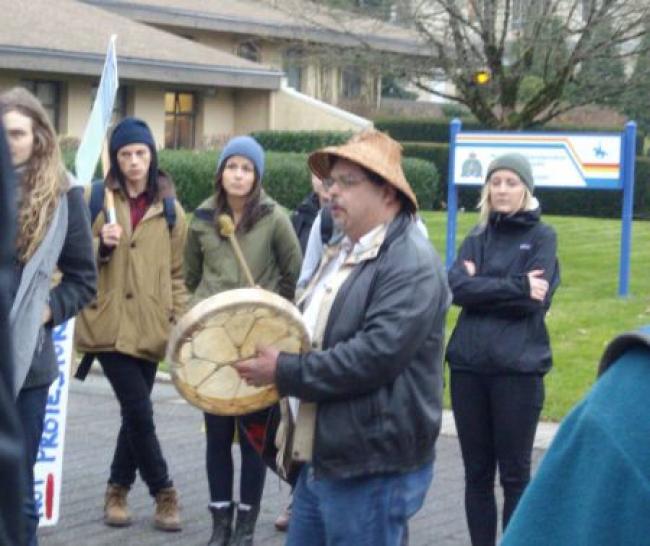 Musqueam singer outside UBC RCMP station