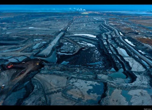 (A land of pits, fumes, and poisoned pools as far as the eye can see. Canada, in its mad quest for oil, has turned a pristine boreal forest into a place that is a stunning likeness to Tolkien’s Mordor. Image source: Garth Lenz’s TED Talk.)