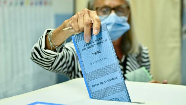 A woman votes at a polling station on Oct. 4, 2021, in Turin, Italy. (Stefano Guidi/Getty Images)