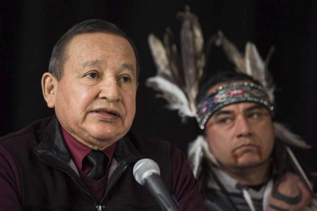 The Grand Chief of the Union of British Columbia Indian Chiefs, Stewart Phillip, gives a news conference with indigenous leaders and politicians opposed to the expansion of the Trans Mountain oil pipeline in Vancouver, Canada on April 16. 2018. Behind is William George, a member of the Tsleil-Waututh First Nation and a guardian at the watch house near Kinder Morgan Inc. Burnaby oil facility.Photo: Darryl Dyck, SUB / Associated Press