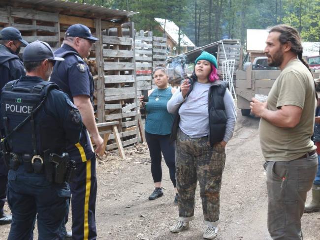 RCMP C-IRG officers face off against occupants at Gidimt’en Camp in June 2022. At the time, police were conducting sweeps through the camp multiple times a day. Photo by Amanda Follett Hosgood.