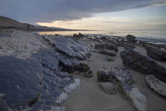 Oil from a broken pipeline covered rocks near Refugio State Beach on Wednesday north of Goleta, Calif. Credit David Mcnew/Getty Images
