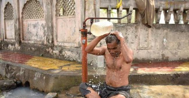 A man tries to cool off during a heatwave in Amritsar, India on April 30, 2022. (Photo: Narinder Nanu/AFP via Getty Images)